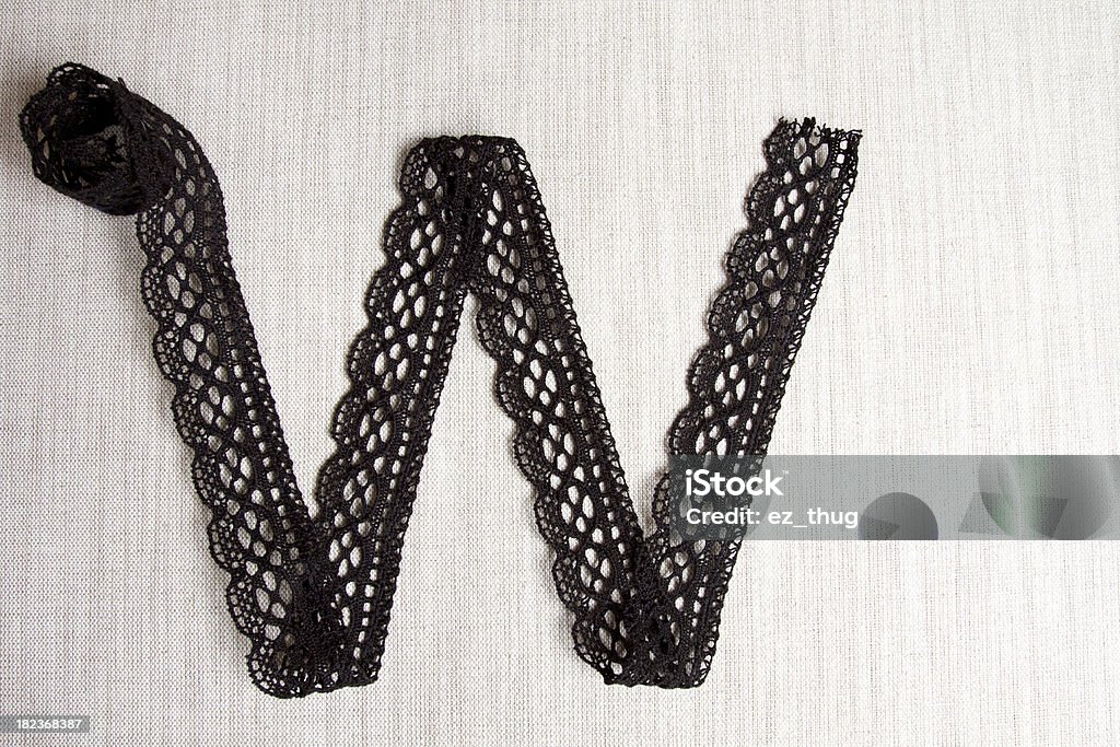 Alphabet series Letter W made of black lace on linen backgroundMore similar images Alphabet Stock Photo