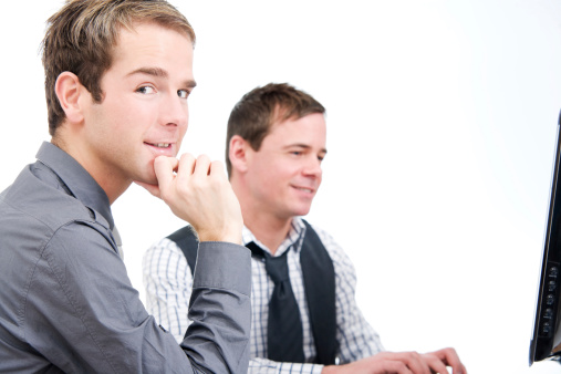 Two Guys Working Two Men Working At A Computer Stock Photo - Download Image Now - 25-29 ...