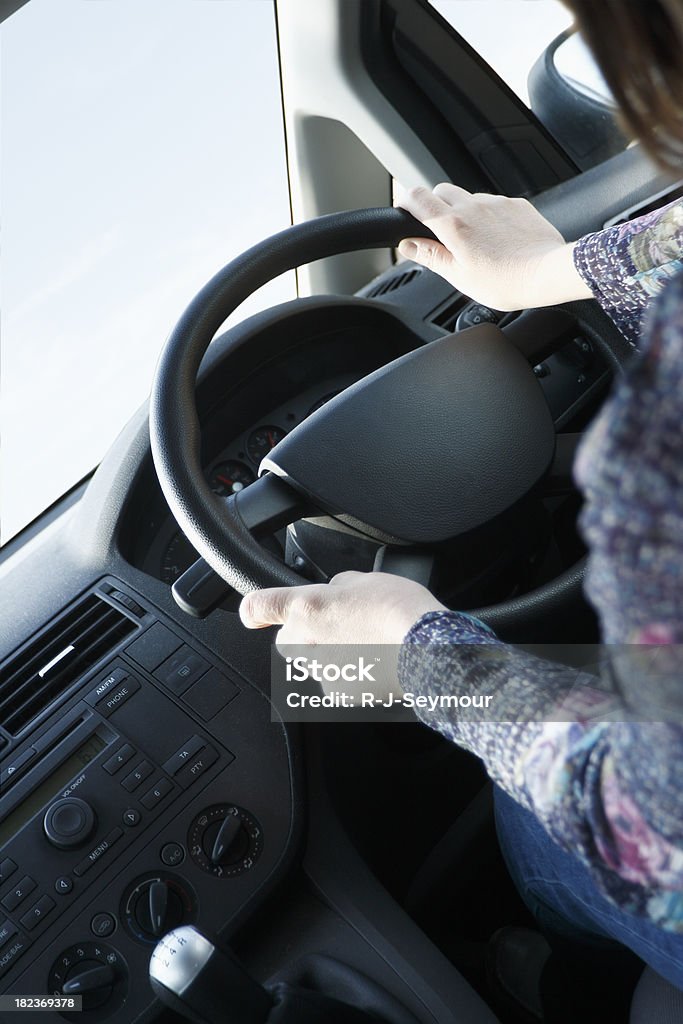 Female Driver "Shot of a woman driving, from over the shoulder." Adult Stock Photo