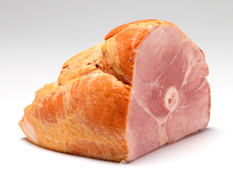 ham cut into pieces isolated on white background, sliced ham in plastic package