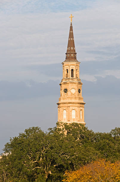 istock Historic church steeple above oak tree 182370244