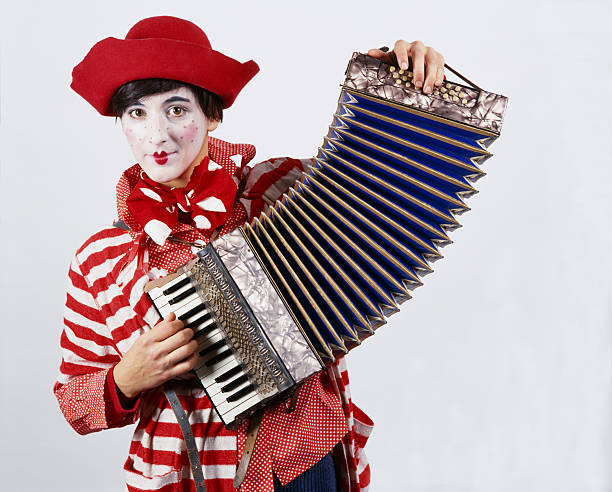 istock Red clown making fun with an accordion 182371117
