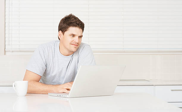 istock Mid adult man working on a laptop from home 182371119