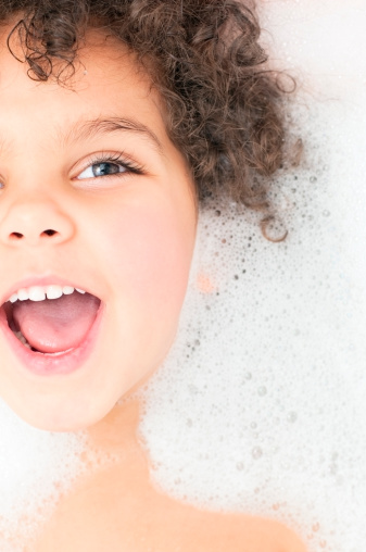 Royalty Free stock photo of 3 years old girl having bubble bath.This file has a