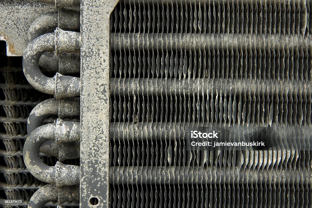 Old Car Radiator An old transmission cooler from a 70's era car rots in a field20070520041 Abstract Stock Photo