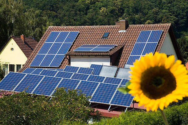 istock House with Solar Panels and a Sunflower 182371523