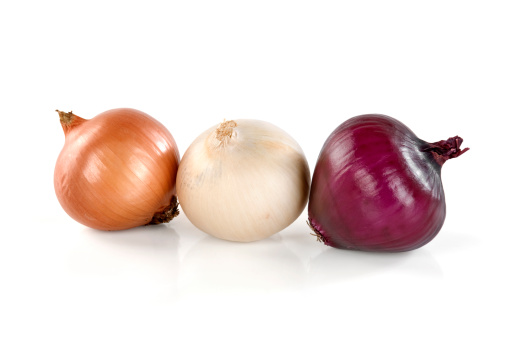 Red yellow and white onions on white background