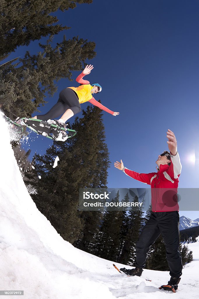 Snowshoe fun Woman jumping into mans arms while snowshoeing.Please see similar images in my portfolio: 30-34 Years Stock Photo