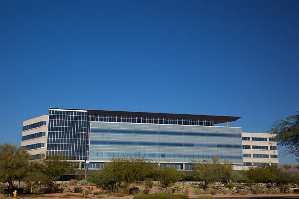 Modern Scottsdale Business Scottsdale Arizona rectangular business building modern 20th century style on a clear day with acacia trees set on a bright blue clear sky background southwest usa architecture building exterior scottsdale stock pictures, royalty-free photos & images