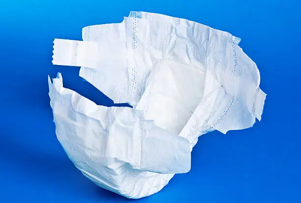 Generic plain diaper isolated on blue background.