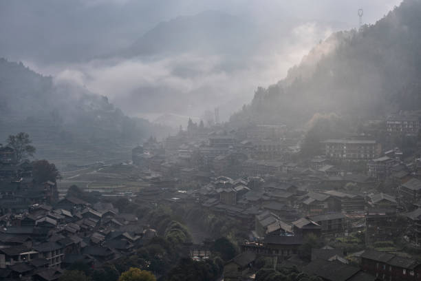 Miao village in a foggy morning, Guizhou Province, China Miao village in a foggy morning in autumn, Guizhou Province, China qiandongnan miao and dong autonomous prefecture stock pictures, royalty-free photos & images