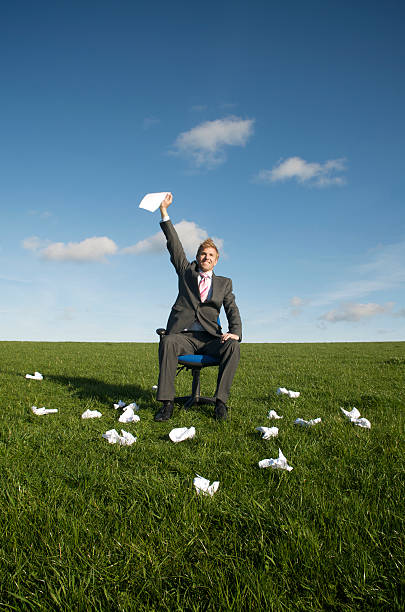 istock Businessman in Meadow Holds Up Final Draft 182374086