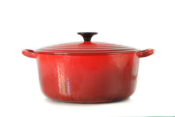 Red casserole dish on white background Well used orange casserole Dish pan stock pictures, royalty-free photos & images