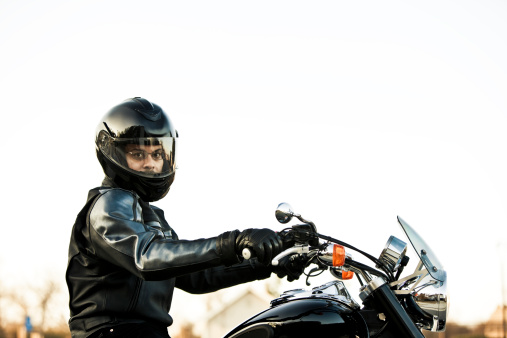 Motorcyclist series. Profile of a male riding his classic sleek cruiser.