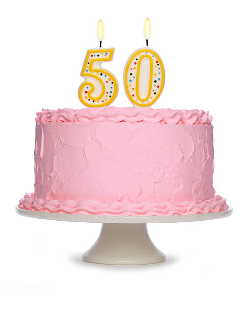 istock Birthday cake decorated with pink icing and candles 182374442