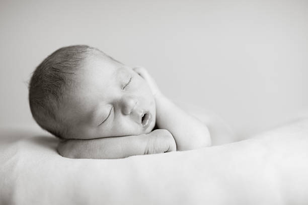 istock Newborn Baby Sleeping Peacefully on Soft Blanket 182374467