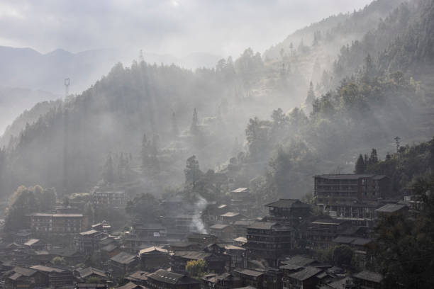 Miao village in a foggy morning, Guizhou Province, China Miao village in a foggy morning in autumn, Guizhou Province, China qiandongnan miao and dong autonomous prefecture stock pictures, royalty-free photos & images