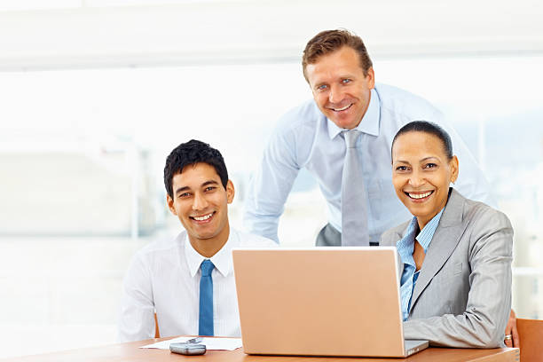 istock Happy business colleagues working on a laptop 182374660
