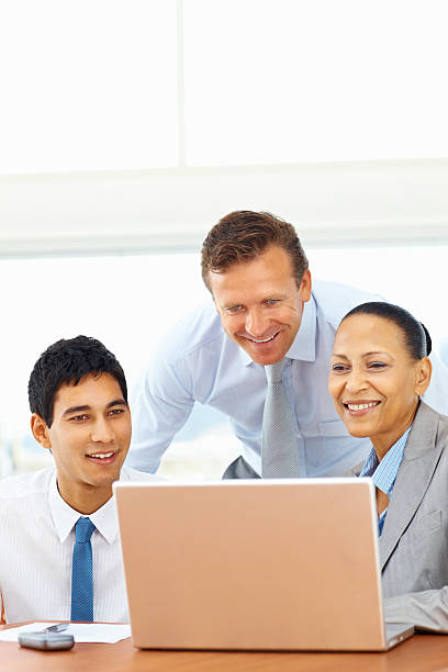 istock Happy business colleagues working on a laptop 182374664