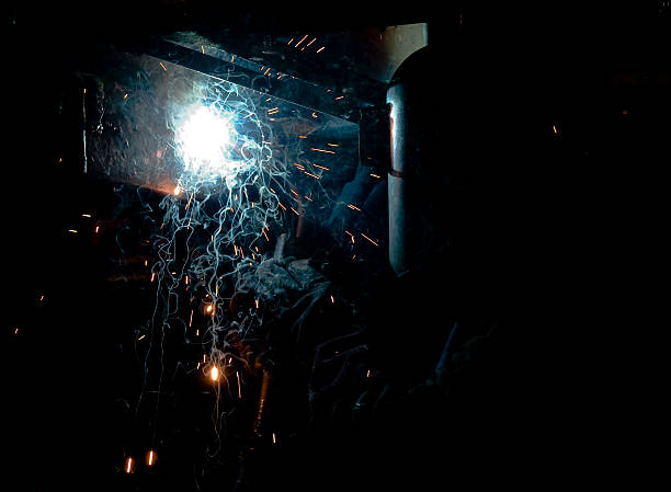 istock Sparks fly during welding in dark, confined space 182374882
