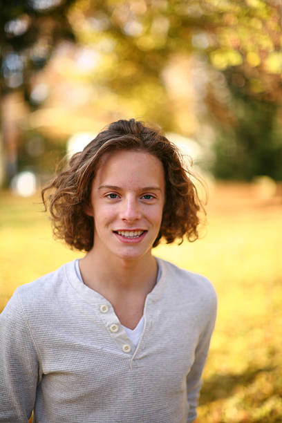 istock smiling cute young man out doors 182375364