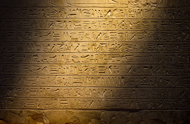 Ancient hieroglyphics dimly lit Hieroglyphics hieroglyphics photos stock pictures, royalty-free photos & images