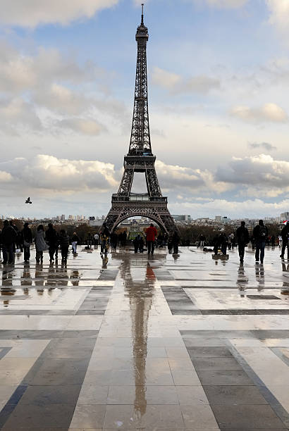 istock People approaching the Paris Eifel tower just after heavy rainfall 182375622