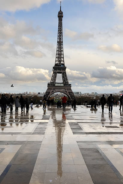 People approaching the Paris Eifel tower just after heavy rainfall stock photo