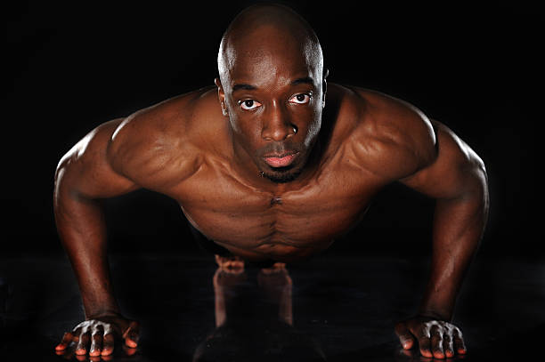 istock Athlete doing push-ups in the dark 182375857