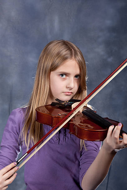 istock Girl playing the violin. 182376004