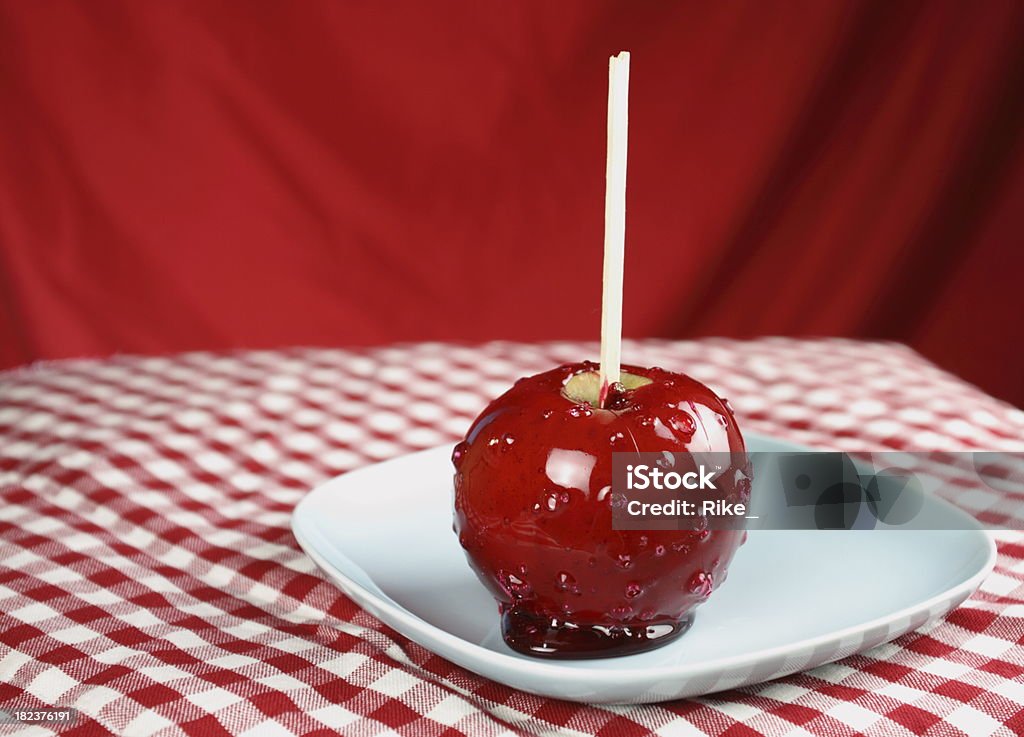 Red candied apple Red candied apple on red background Taffy Apple Stock Photo