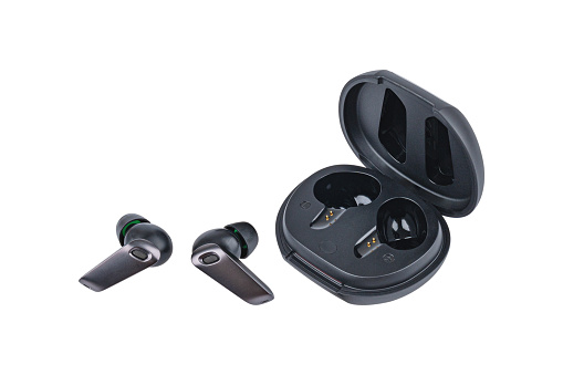 Wireless black bluetooth earphones with contactless charging isolated on white background.