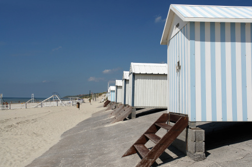 A row of beach huts that line the sandy beach at Hardelot which is situted next to Le Touquet in Northern France.