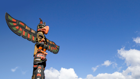 First Nations Totem Poles during a fall season at Stanley Park in Vancouver, British Columbia, Canada.