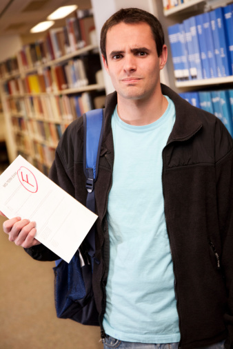 Upset College Student Holding His Failing Exam Paper.See more from this series: