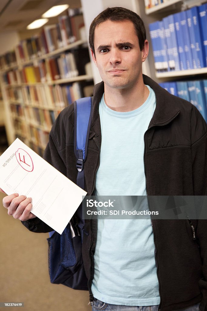 Upset College Student Holding His Failing Exam Paper Upset College Student Holding His Failing Exam Paper.See more from this series: Letter F Stock Photo