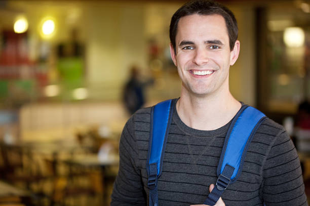 istock Male College Student Standing in the University Cafeteria 182376423