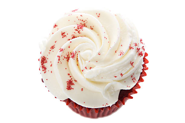 Delicious creme cheese frosting in a swirl pattern on a red velvet cupcake. Isolated on a white background with selective focus. Room for copy.Find more yummy Cupcakes here!