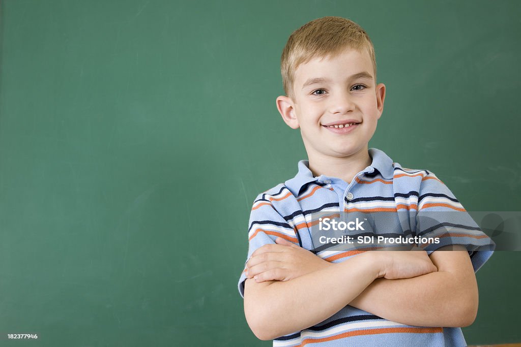 Menino de escola com orgulho em pé na frente do Chalkboard - Royalty-free Em Frente de Foto de stock