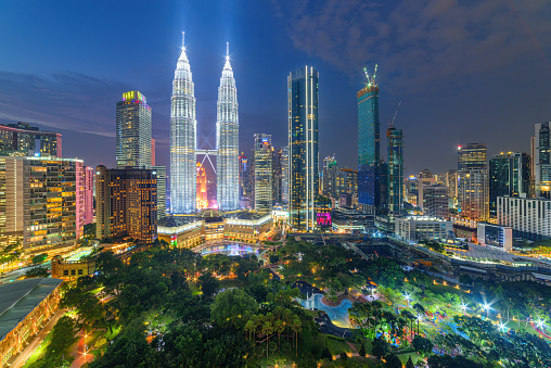 Night aerial view of the KLCC Park and the Petronas Twin Towers in Kuala Lumpur, Malaysia. The urban park in Kuala Lumpur City Center is a popular tourist attraction of Asia. Kuala Lumpur skyline.