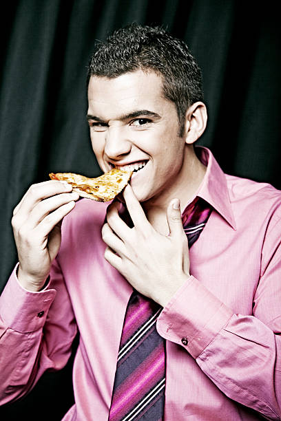 istock Young business man eating pizza 182378067