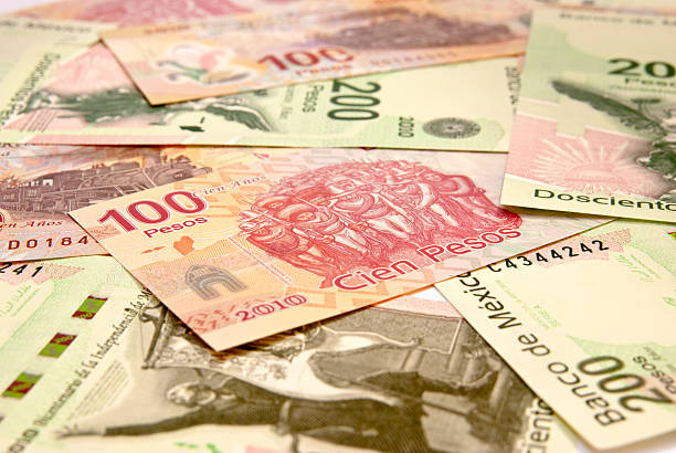 One and Two Hundred Bicentennial Pesos A close view of Mexican Bicentennial Pesos (2010). mexican currency stock pictures, royalty-free photos & images