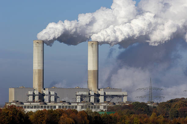 Two smokestacks of a power plant Coal burning power plant with pollution. smoke stack stock pictures, royalty-free photos & images