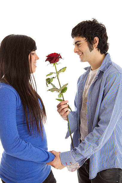istock Young man gives his girlfriend a rose 182379688