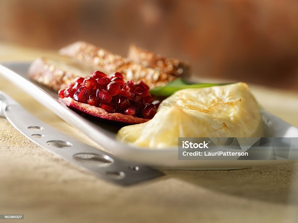 Baked Brie in filo Pastry "Baked Brie in filo with Pomegranate seeds, Crackers and Bread -Photographed on Hasselblad H1-22mb Camera" Baguette Stock Photo