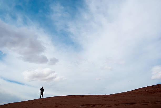 istock sky hiker silhouette landscape sandstone abstract 182381500
