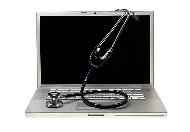Laptop and Stethoscope stock photo