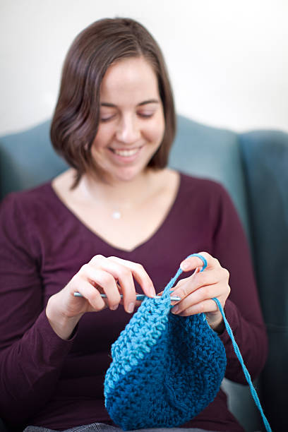 istock Happy Young Woman Crocheting 182382085