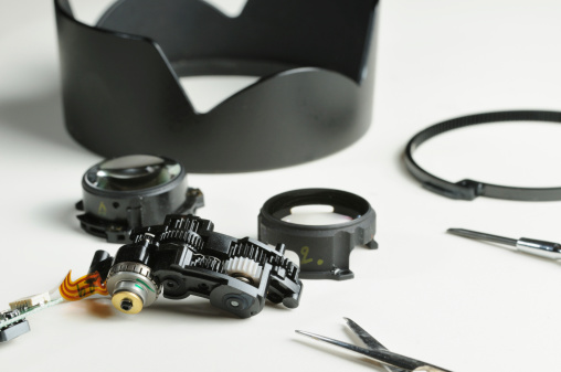 Parts of slr lens with tools being repaired