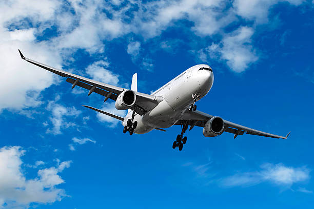 istock jet airplane landing in bright sky 182382384
